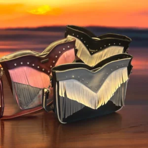 Three fringed crossbody bags at sunset.