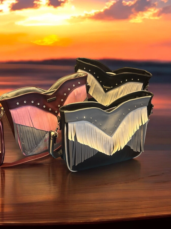 Three fringed crossbody bags at sunset.