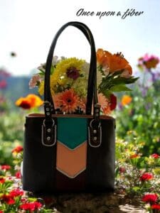 Multicolored leather handbag with flowers.