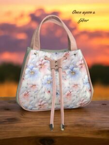 Floral handbag, pastel pink, drawstring closure.