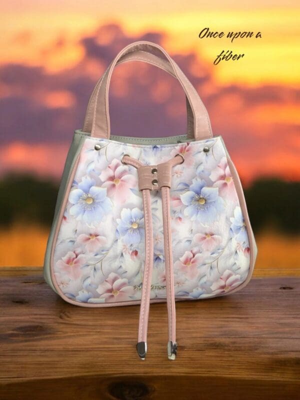 Floral handbag, pastel pink, drawstring closure.