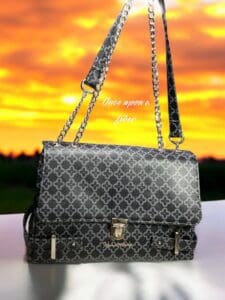 Black patterned handbag with chain strap.