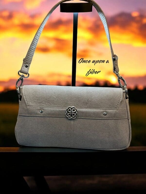 Elegant light grey crossbody bag.